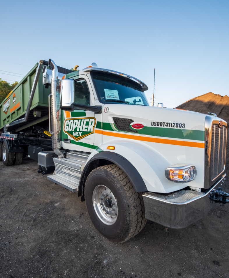 Green roll-off dumpsters lined up outdoors, available for rental in Jacksonville