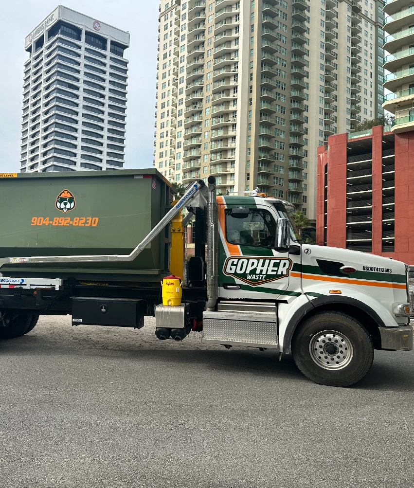 Gopher Waste roll-off truck servicing downtown Jacksonville commercial site
